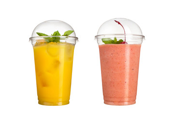 Delicious fruit smoothies in plastic cups, on a white background. Two cocktails with a taste of pineapple and cherry.