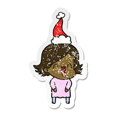 distressed sticker cartoon of a laughing woman wearing santa hat