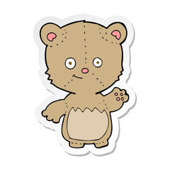 sticker of a cartoon little teddy bear waving