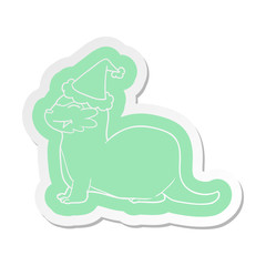 laughing otter cartoon  sticker of a wearing santa hat