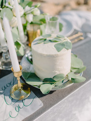 Wedding sweet cake with cream and eucalyptus leaves for decoration. Wedding dinner