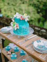 Wedding turquoise cake with flowers and gifts. Wedding banquet