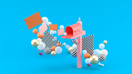 A floating letter from a mailbox surrounded by colorful balls on a blue background.-3d rendering.