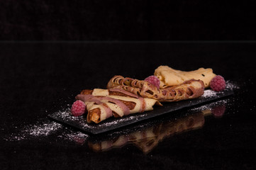 crepes on a plate with raspberries