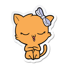 sticker of a cartoon cat with bow on head