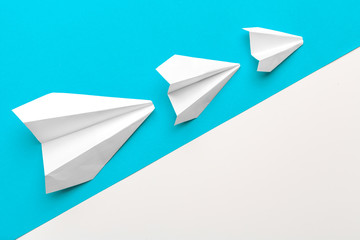 paper airplanes on pastel  colored background. childhood,freedom and diversity concept