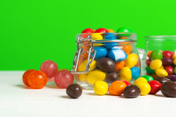 Bottles with sweet candies on table
