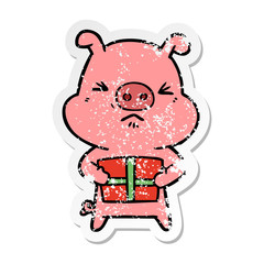 distressed sticker of a cartoon angry pig with christmas present