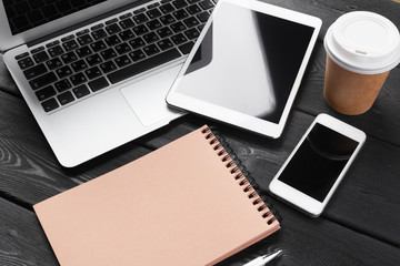 Open laptop with digital tablet and smartphone close up