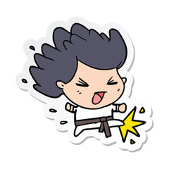sticker of a cartoon kicking karate champ