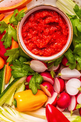 Plate with fresh, raw vegetables and sauce.