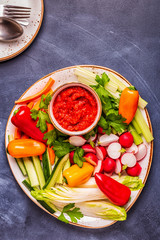 Plate with fresh, raw vegetables and sauce.