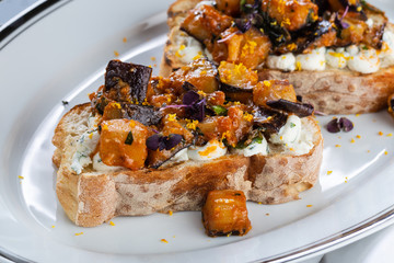 Eggplant and tomato caponata on crusty white bread