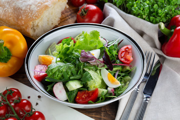 Salad with eggs, tomatoes and cucumbers