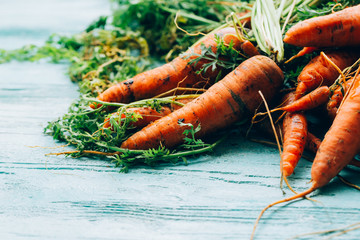 lot of carrots on a wooden background