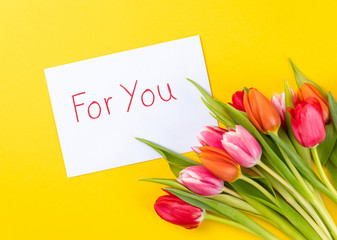 colorful tulips on a yellow background with text for you