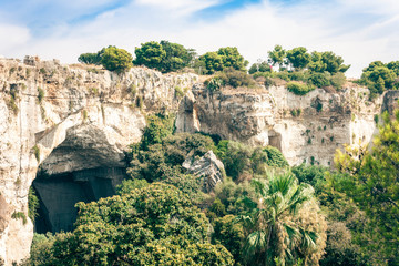 Archeological park, rocks near Greek Theatre of Syracuse, ruins of ancient monument, Sicily, Italy.