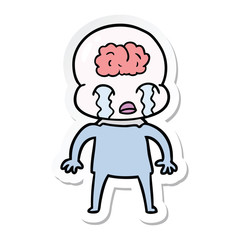 sticker of a cartoon big brain alien crying