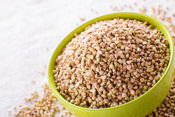 Natural fresh green buckwheat in bowl on white background.