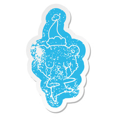 crying polar bear cartoon distressed sticker of a wearing santa hat