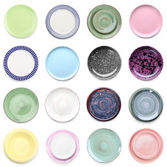 Set of different ceramic plates on white background