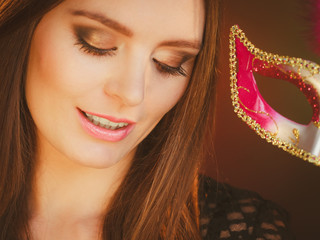 Woman holds carnival mask closeup