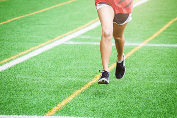 young sport girl running on sport field