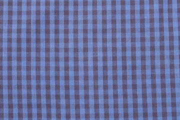 The background texture of the plaid fabric is blue. Abstract checkered background.