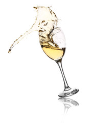 Glass with splashing wine on white background
