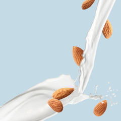 Splash of almond milk on light blue background