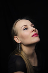 Portrait of a beautiful young woman on a black background.