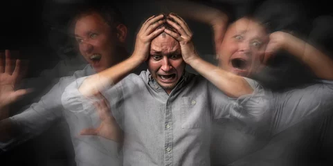 Fotobehang Man having panic attack on dark background © Pixel-Shot
