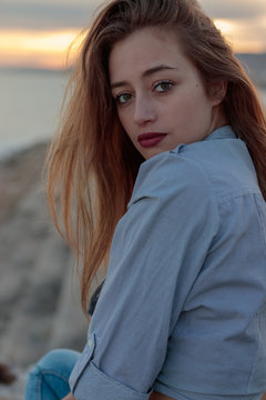 Young woman during the sunset in the mediterranean