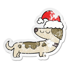 distressed sticker of a cartoon dog wearing christmas hat