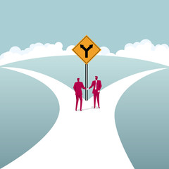  Businessmen shake hands at the fork road. Business cooperation concept.