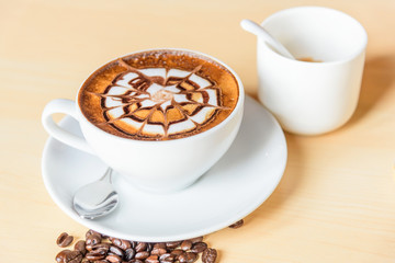 hot cappuccino coffee with nice pattern foam on table
