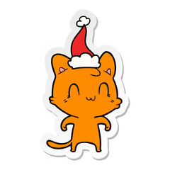 sticker cartoon of a happy cat wearing santa hat