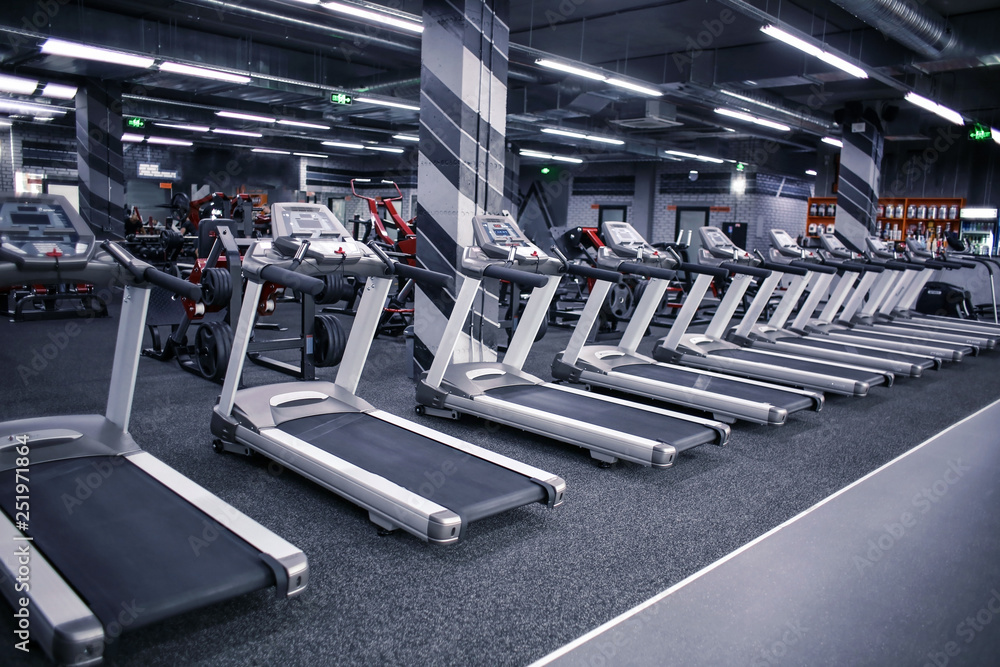 Wall mural modern equipment in new gym indoors