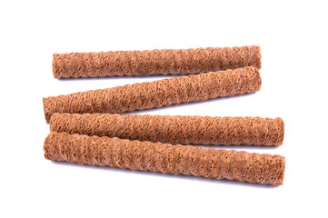 Waffle rolls with chocolate cream on white background