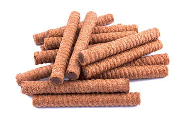 Waffle rolls with chocolate cream on white background