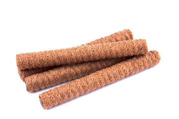 Waffle rolls with chocolate cream on white background