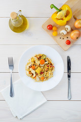 Warm chicken and quinoa salad on a white wooden table