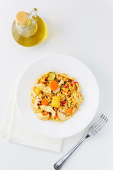 Warm chicken and quinoa salad on a white wooden table