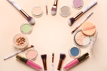 Frame made of cosmetics and accessories on color background