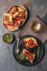 Tasty Italian focaccia and basil sauce on grey table