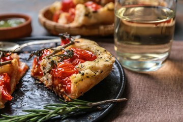 Plate with tasty Italian focaccia on table, closeup