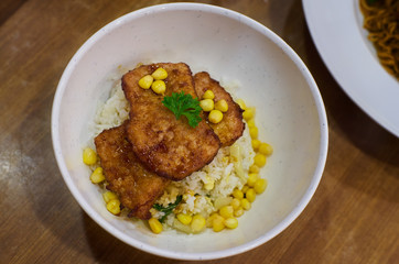 Fried pork chop with rice and corn . Asian delicacies foods .
