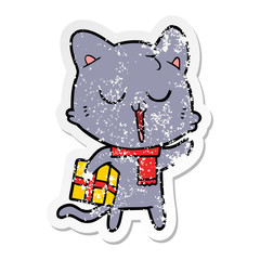 distressed sticker of a cartoon cat with gift