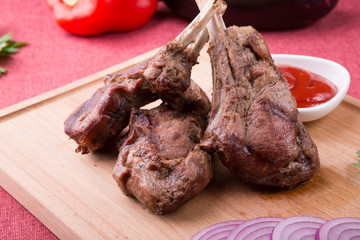 Grilled lamb chops served with ketchup