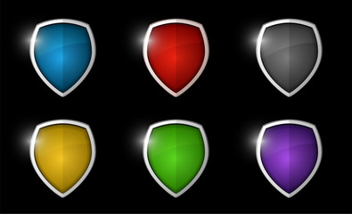 Realistic shining shield icon pack isolated on black background: blue, red, grey, yellow, green, violet. Defense, safety, privacy, security, safeguard or antivirus concept. Vector illustration